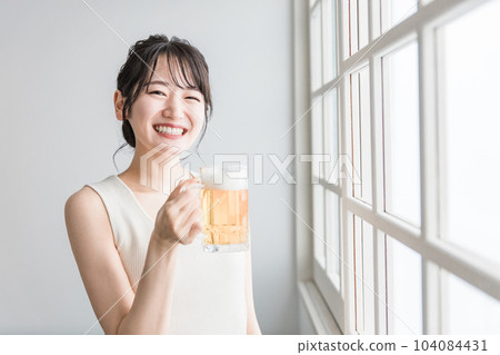Asian woman drinking beer at home (beer mug) Asian woman drinking beer at home (beer mug) 104084431