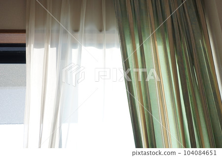 Sunlight hitting the curtains. 104084651