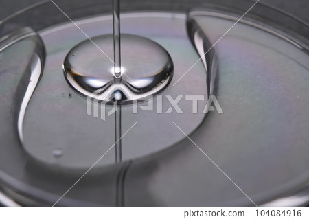 A juicy drop of gel on a grey background. A juicy drop of gel on a grey background. 104084916