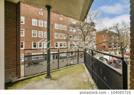 the view from an apartment balcony in south london, with cars parked on the street and bricked buildings behind the view from an apartment balcony in south london, with cars parked on the street and bricked buildings behind 104085728