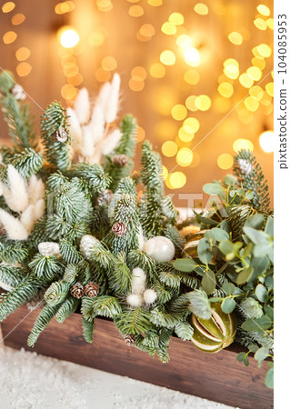 Christmas wooden box with fir branches for the holiday. The new year celebration. European flower shop Christmas wooden box with fir branches for the holiday. The new year celebration. European flower shop 104085953
