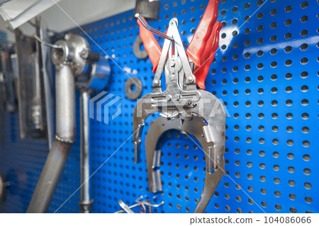 Tools of Car mechanic for a new piston for the engine, overhaul. Interior of a car repair shop. Tools of Car mechanic for a new piston for the engine, overhaul. Interior of a car repair shop. 104086066