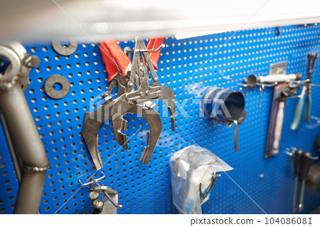 Tools of Car mechanic for a new piston for the engine, overhaul. Interior of a car repair shop. Tools of Car mechanic for a new piston for the engine, overhaul. Interior of a car repair shop. 104086081