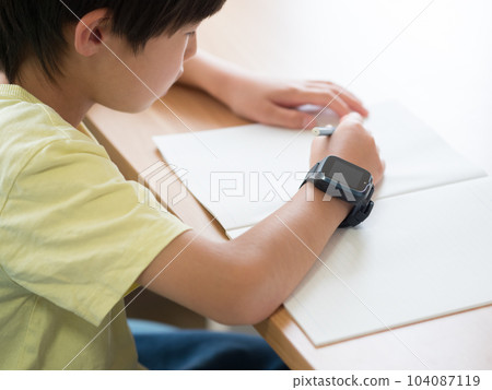 A boy studying with a smart watch A boy studying with a smart watch 104087119