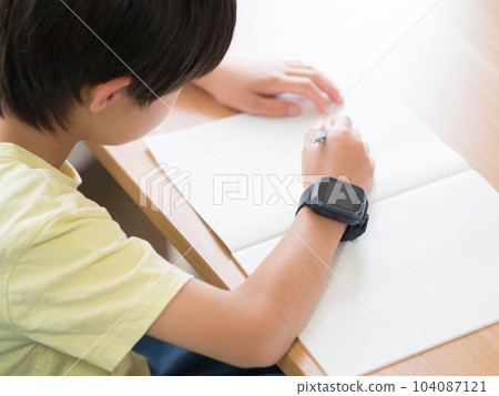 A boy studying with a smart watch A boy studying with a smart watch 104087121