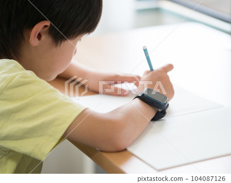 A boy studying with a smart watch A boy studying with a smart watch 104087126