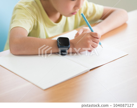 A boy studying with a smart watch A boy studying with a smart watch 104087127