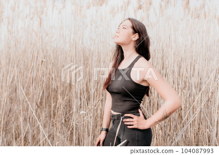 Happy young smiling woman with freckles outdoors portrait. Soft sunny colors. Outdoor close-up portrait of a young brunette woman and looking to the camera, posing against autumn nature background Happy young smiling woman with freckles outdoors portrait. Soft sunny colors. Outdoor close-up portrait of a young brunette woman and looking to the camera, posing against autumn nature background 104087993