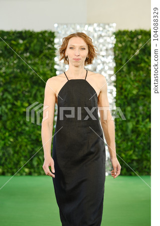 Portrait of smiling middle aged woman in linen sundress 104088329