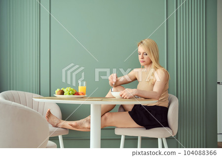 Woman has breakfast at home Woman has breakfast at home 104088366