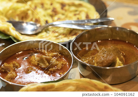 Indian curry in silver stainless steel tableware 104091162