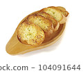 Several slices of garlic bread were placed on a wooden plate. 104091644