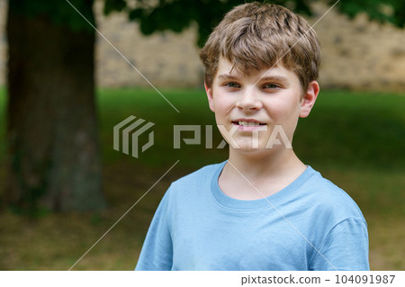 Portrait of positive preteen school kid boy. Beautiful happy child looking at the camera. Schoolboy smiling. 104091987