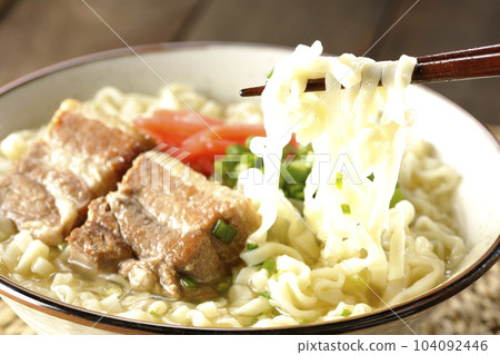 Eat Okinawa soba with pork ribs, plenty of small green onions and pickled ginger Eat Okinawa soba with pork ribs, plenty of small green onions and pickled ginger 104092446