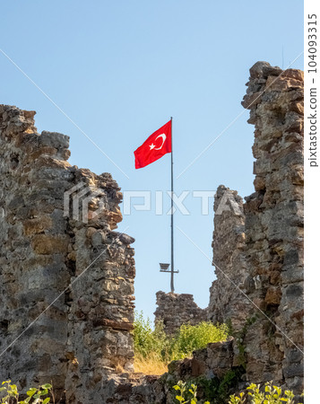 Flag of Turkey in ruins of the ancient Byzantine city of Naula in present-day Turkey 104093315