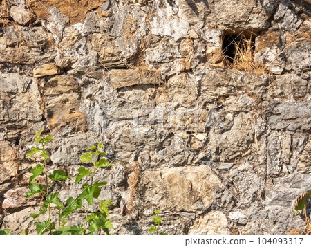 Fragment of the wall of an ancient building made of stones Fragment of the wall of an ancient building made of stones 104093317