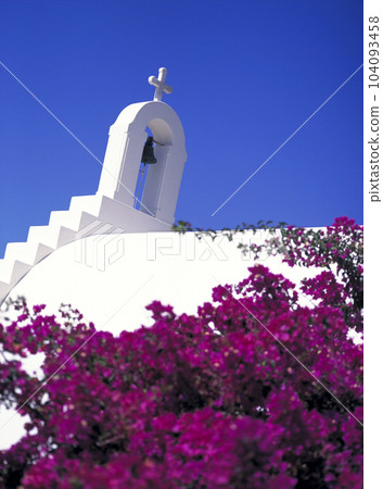 Greek basilica cross and bougainvillea, blue sky 104093458