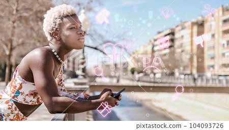 Black transgender using smartphone on embankment 104093726