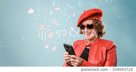 Cheerful aged woman in red clothes using smartphone Cheerful aged woman in red clothes using smartphone 104093728