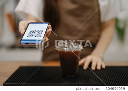 Closeup shot of cashier hands. Seller using touch smartphone for accepting client customer payment. Small business of coffee shop. Closeup shot of cashier hands. Seller using touch smartphone for accepting client customer payment. Small business of coffee shop. 104094039