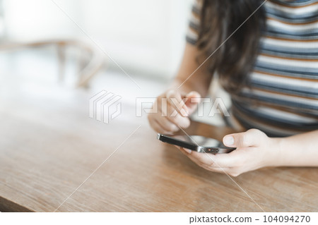 Women's Hands holding cell telephone working mobile devices. smart phone technology e-commerce concept Women's Hands holding cell telephone working mobile devices. smart phone technology e-commerce concept 104094270
