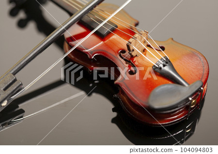 Violin with bow on black background. 104094803