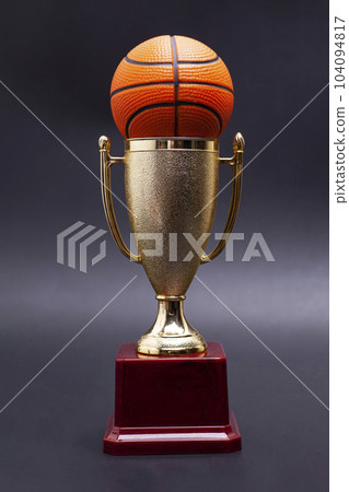 Gold cup with basketball ball on a black background 104094817