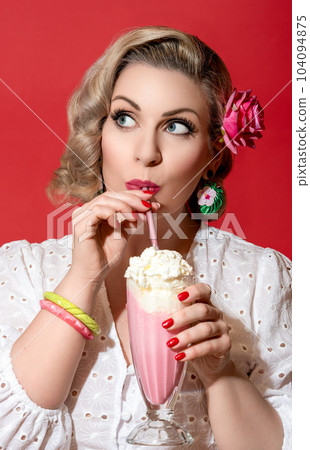 Woman drinking milkshake. Portrait of a retro style woman. 104094875