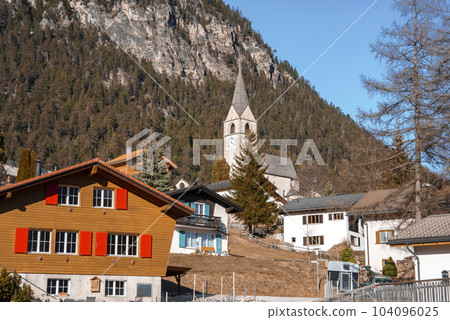Beautiful church and houses with majestic mountain in background at Swiss Alps. Winter holiday travel concept Beautiful church and houses with majestic mountain in background at Swiss Alps. Winter holiday travel concept 104096025