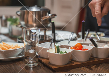 Finger pointing at fresh salad in bowls on buffet counter in hotel Finger pointing at fresh salad in bowls on buffet counter in hotel 104096684