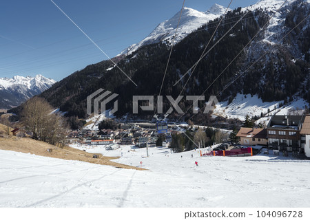Cable cars over snow covered land with mountains in background during winter vacation, winter holiday travel concept Cable cars over snow covered land with mountains in background during winter vacation, winter holiday travel concept 104096728
