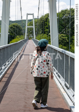 Kawaba Village A woman crossing the Fureai Bridge Kawaba Village A woman crossing the Fureai Bridge 104096855