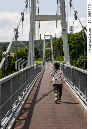 Kawaba Village A woman crossing the Fureai Bridge Kawaba Village A woman crossing the Fureai Bridge 104096860