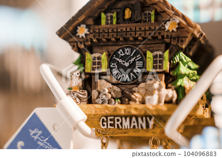 Closeup of carved wooden clock decor with Germany text at ski resort, winter holiday travel concept 104096883