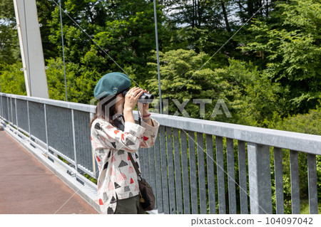 Kawaba Village A woman looking at the scenery from the Fureai Bridge Kawaba Village A woman looking at the scenery from the Fureai Bridge 104097042
