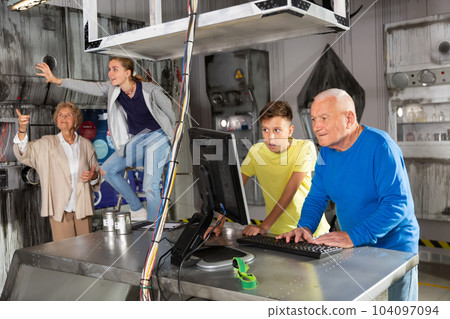 Young boy and girl with grandparents in escape room Young boy and girl with grandparents in escape room 104097094