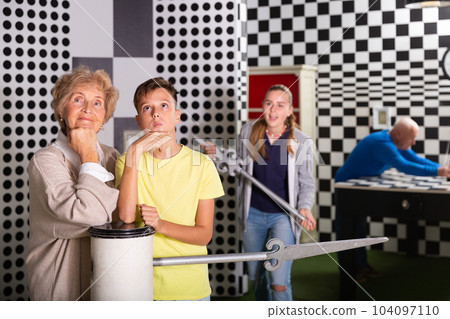 Boy together with the elderly grandmother thought about solving the puzzle in quest room 104097110