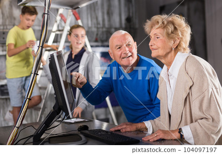 Family is using PC in time having fun together in lost labroom 104097197