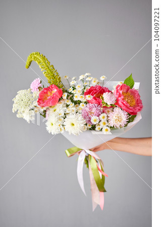 Beautiful bouquet with peonies flowers in woman hand. Floral shop concept . Beautiful fresh cut bouquet. Flowers delivery Beautiful bouquet with peonies flowers in woman hand. Floral shop concept . Beautiful fresh cut bouquet. Flowers delivery 104097221