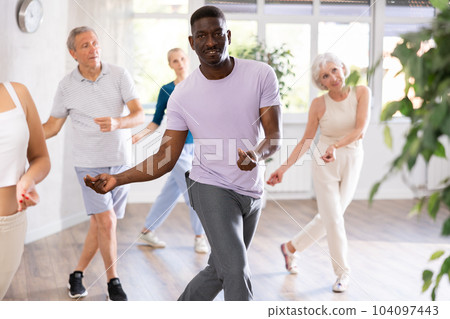 Group of multiethnic mature people dancing modern dance 104097443