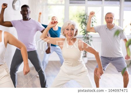 Mature men and women practicing Hip-hop dance in training hall Mature men and women practicing Hip-hop dance in training hall 104097471