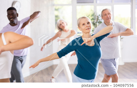 Senior woman dancing hip hop in studio practicing dance number. 104097556