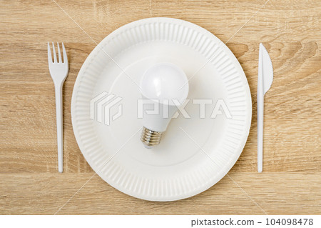 LED light bulb in a white disposable plate LED light bulb in a white disposable plate 104098478