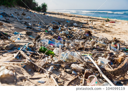 Tropical ocean beach and plastic trash in Bali. Pollution by plastic rubbish on coastline 104099119