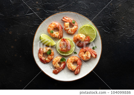 Shrimps, overhead flat lay shot. Fried shrimp with lime on a plate Shrimps, overhead flat lay shot. Fried shrimp with lime on a plate 104099886