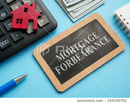 Wooden plate with inscription mortgage forbearance and model of house. Wooden plate with inscription mortgage forbearance and model of house. 104100762