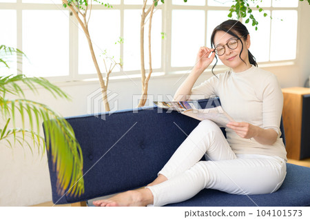 Middle woman in eyeglasses looking at pamphlet Middle woman in eyeglasses looking at pamphlet 104101573