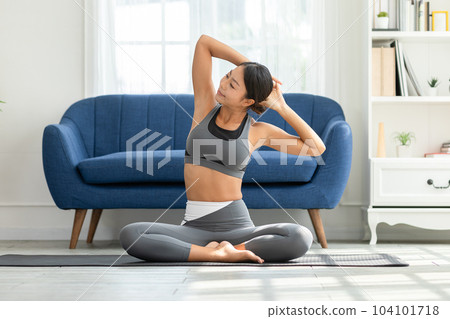 Calm of Asian woman in sportwear stretching muslce to warm up breathing and meditation with yoga at home,Healthy woman doing yoga Feeling so comfortable and relax,Wellness Yoga Healthcare Concept 104101718