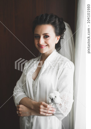 Beautiful bride wearing fashion wedding dress with feathers with luxury delight make-up and hairstyle, studio indoor photo shoot Beautiful bride wearing fashion wedding dress with feathers with luxury delight make-up and hairstyle, studio indoor photo shoot 104101980