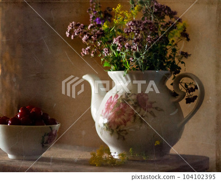 Still life with wildflowers in a vintage teapot. Nearby on a wooden table are cherries in a ceramic bowl. Image stylization for old photos with scratches. 104102395